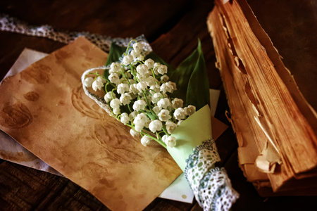 vintage effect on photo bouquet of lilies of the valley and space textの写真素材