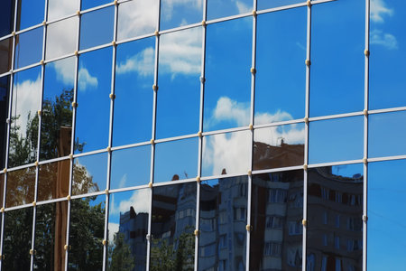 glass office building reflection of sky cloud
