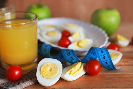 breakfast tomato with eggs on wooden backgroundの写真素材