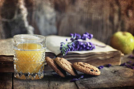 cookies and old retro book on a wooden tableの写真素材