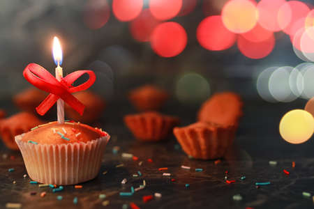 birthday cupcake with a candle on tableの写真素材