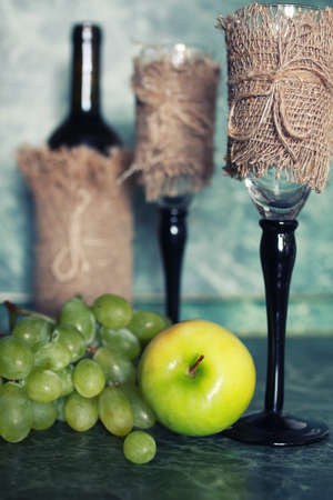 wine bottle with green grapesの写真素材