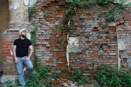 man stand near old red brick industrial wall background