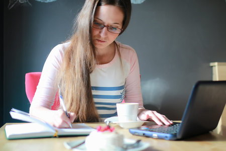 girl in a cafe for a cup of coffee with the notebook