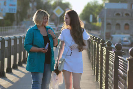 two woman outdoor walk in sunny summer dayの写真素材