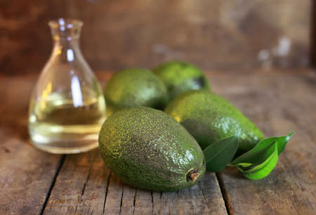 avocado and oil on old wooden backgroundの写真素材