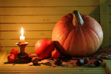pumpkin and lamp on wooden tableの写真素材