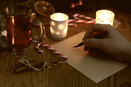 hand writing Christmas letter on the tableの写真素材