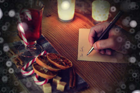 hand writing Christmas letter on the tableの写真素材