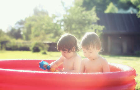 baby splashing in the pool outdoors summerの写真素材