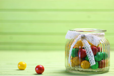 color candy in glass jar on holiday table