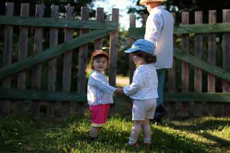 kids walk with grandfather in summer outdoorの写真素材