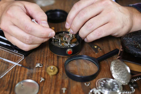 watch clock repairs man working in processの写真素材