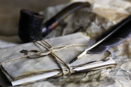 old paper letter and feather retro composition