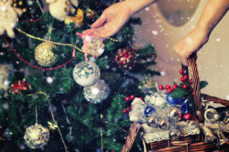 Christmas toys for fir tree in a wicker basketの写真素材