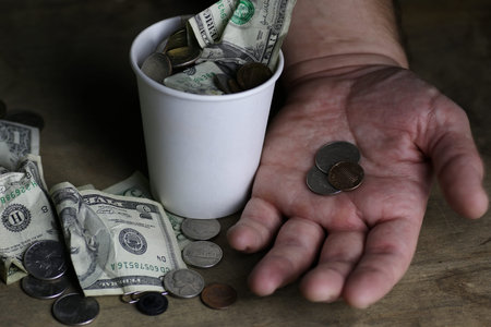 change and crumpled banknote on dirty table