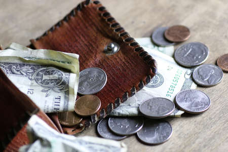 change and crumpled banknote on dirty tableの写真素材