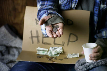homeless man ask help on a boardの写真素材