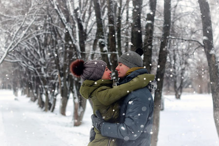 young people outdoor in the park in snowy winterの写真素材