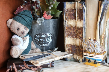 retro toy bear and old books with feather letterの写真素材
