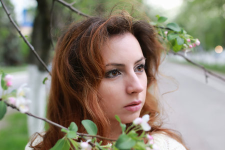 portrait of a happy young girl of European appearance with warm spring sunny day