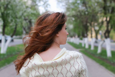 portrait of a happy young girl of European appearance with warm spring sunny dayの写真素材