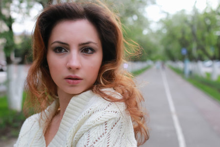 portrait of a happy young girl of European appearance with warm spring sunny dayの写真素材