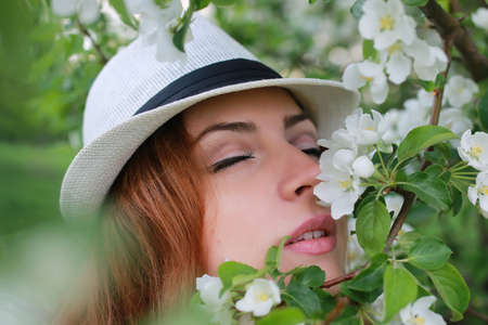 portrait of a happy young girl of European appearance with warm spring sunny dayの写真素材