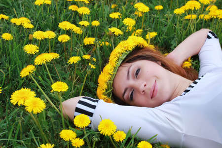 portrait of a cute beautiful girl of European appearance on nature in a summer dayの写真素材