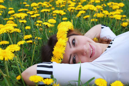 portrait of a cute beautiful girl of European appearance on nature in a summer dayの写真素材
