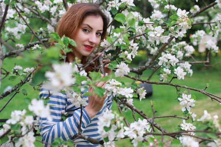 portrait of a cute beautiful girl of European appearance on nature in a summer dayの写真素材
