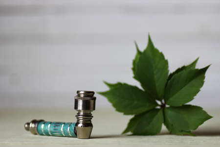 drug addiction concept bong for smoking marijuana and a bag on a wooden backgroundの写真素材