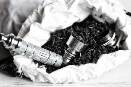 drug addiction concept bong for smoking marijuana and a bag on a wooden backgroundの写真素材