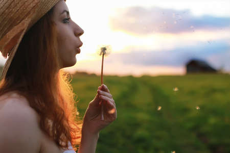 portrait of a cute beautiful girl of European appearance on nature in a summer dayの写真素材