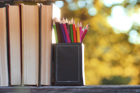 a stack of books to prepare for the school year on a table in the street