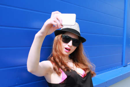 Portrait of a cute girl hipster on the background wall color Supermarketの写真素材