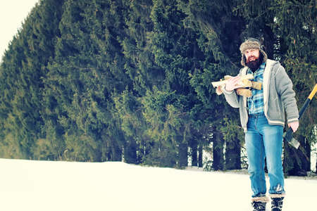 bearded handsome man went into the forest with an ax to produce wood for the furnaceの写真素材
