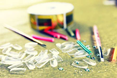 a small set of detail for manicure on a gold backgroundの写真素材