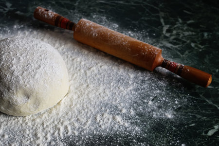 Food crumbly dough from flour on the chef's table with the help of a rolling pinの写真素材