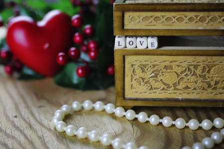 jewelry items on a wooden table in the texture of patterned wooden boxの写真素材