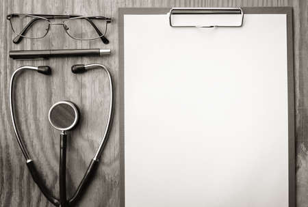 background papers and notebooks on a wooden table bright texturalの写真素材