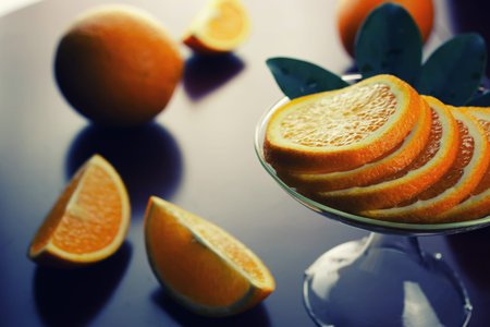 ripe fresh juicy oranges sliced on a glass plate