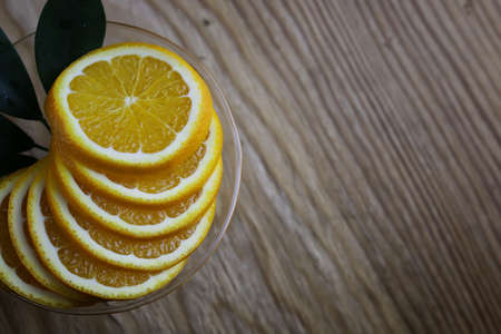 ripe fresh juicy oranges sliced on a glass plateの写真素材