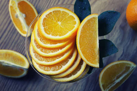 ripe fresh juicy oranges sliced on a glass plateの写真素材