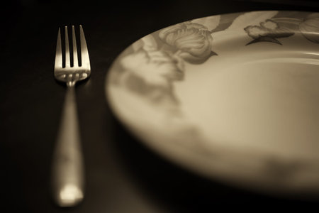 black and white picture fork on an empty plate diningの写真素材