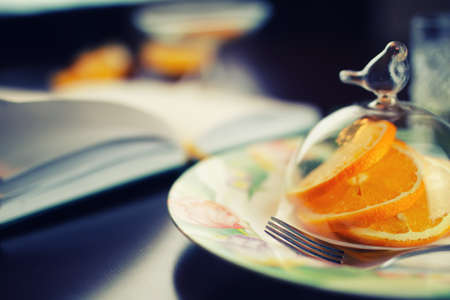 ripe fresh juicy oranges sliced on a glass plateの写真素材