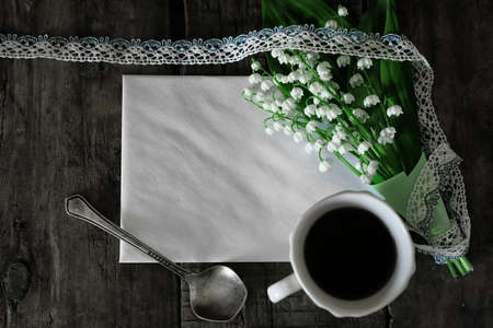 old shabby wooden painted background and a beautiful bouquet of fresh white flowers lily of the valleyの写真素材