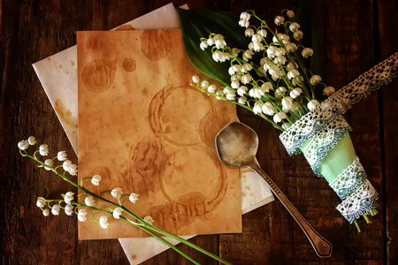 old shabby wooden painted background and a beautiful bouquet of fresh white flowers lily of the valleyの写真素材