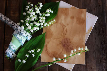 old shabby wooden painted background and a beautiful bouquet of fresh white flowers lily of the valleyの写真素材