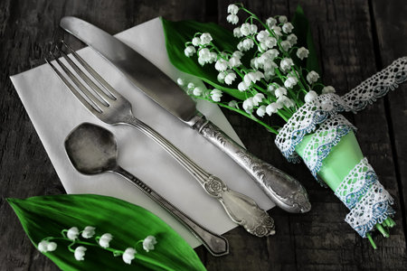 old shabby wooden painted background and a beautiful bouquet of fresh white flowers lily of the valleyの写真素材